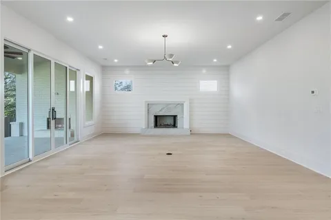 an empty room with fireplace and windows