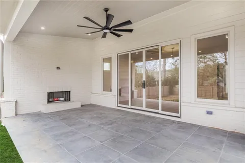 a view of an empty room with a fireplace and a window