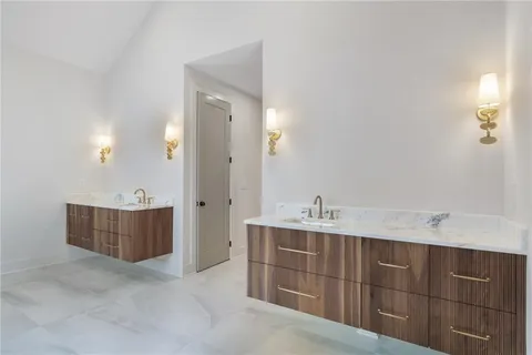 a bathroom with a sink vanity and mirror