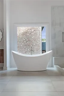 a white and white tub sitting in a bathroom