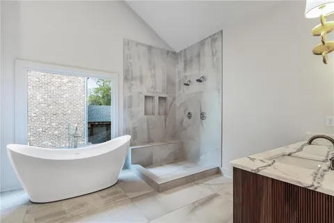 a white tub sitting next to a shower