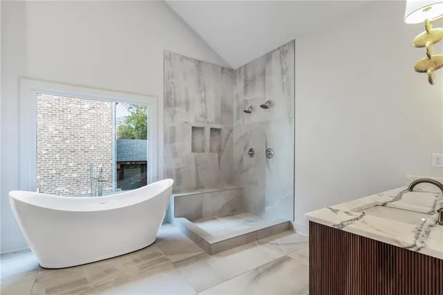 a white tub sitting next to a shower