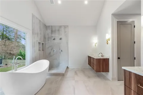 a spacious bathroom with a bathtub and shower