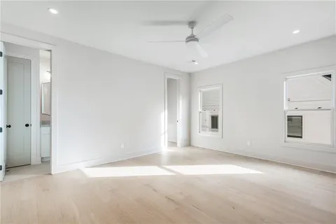 an empty room with a empty space and windows