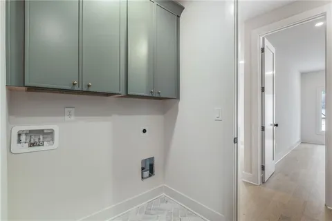 an empty room with windows and chandelier fan