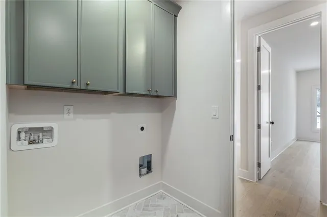 an empty room with windows and chandelier fan
