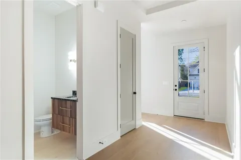 a room with a bench and a hallway