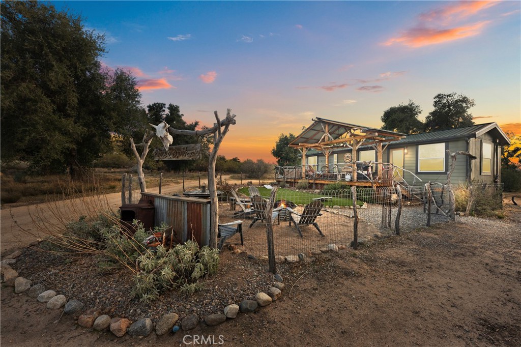 a view of a house with a backyard and sitting area