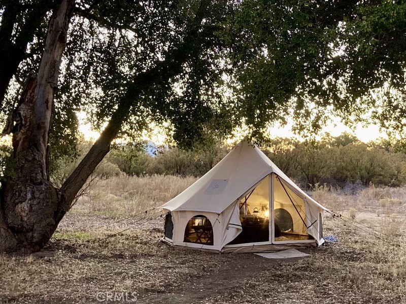 30415 Chihuahua Valley Road Warner Springs, CA 92086 - Photo 61 of 75 a view of a wooden house with a yard and large trees