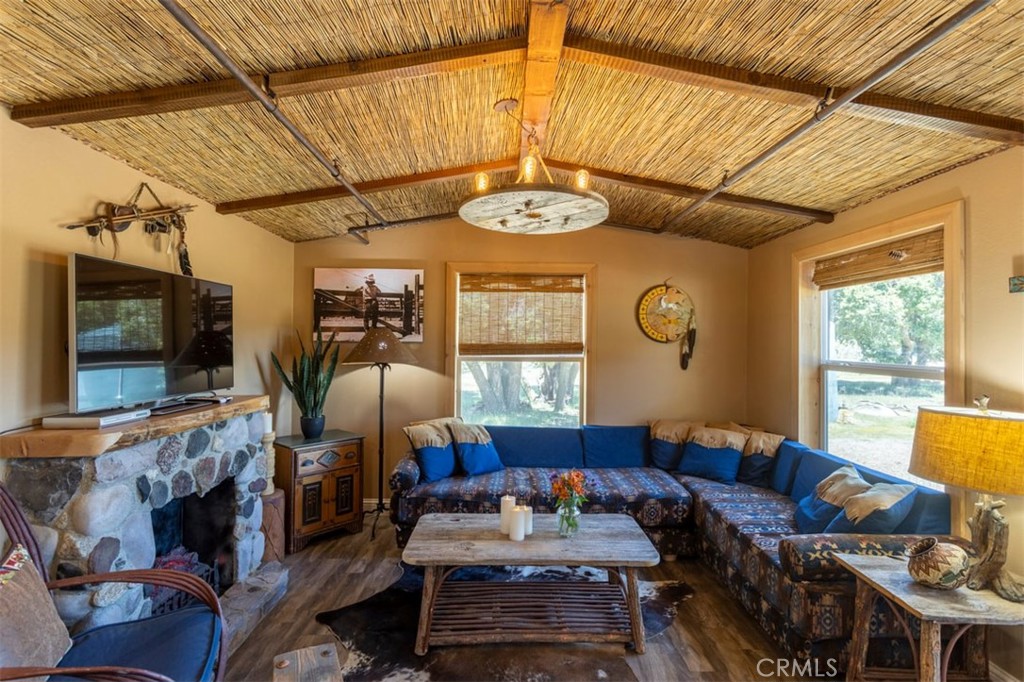 30415 Chihuahua Valley Road Warner Springs, CA 92086 - Photo 7 of 75 a living room with furniture a fireplace and a flat screen tv