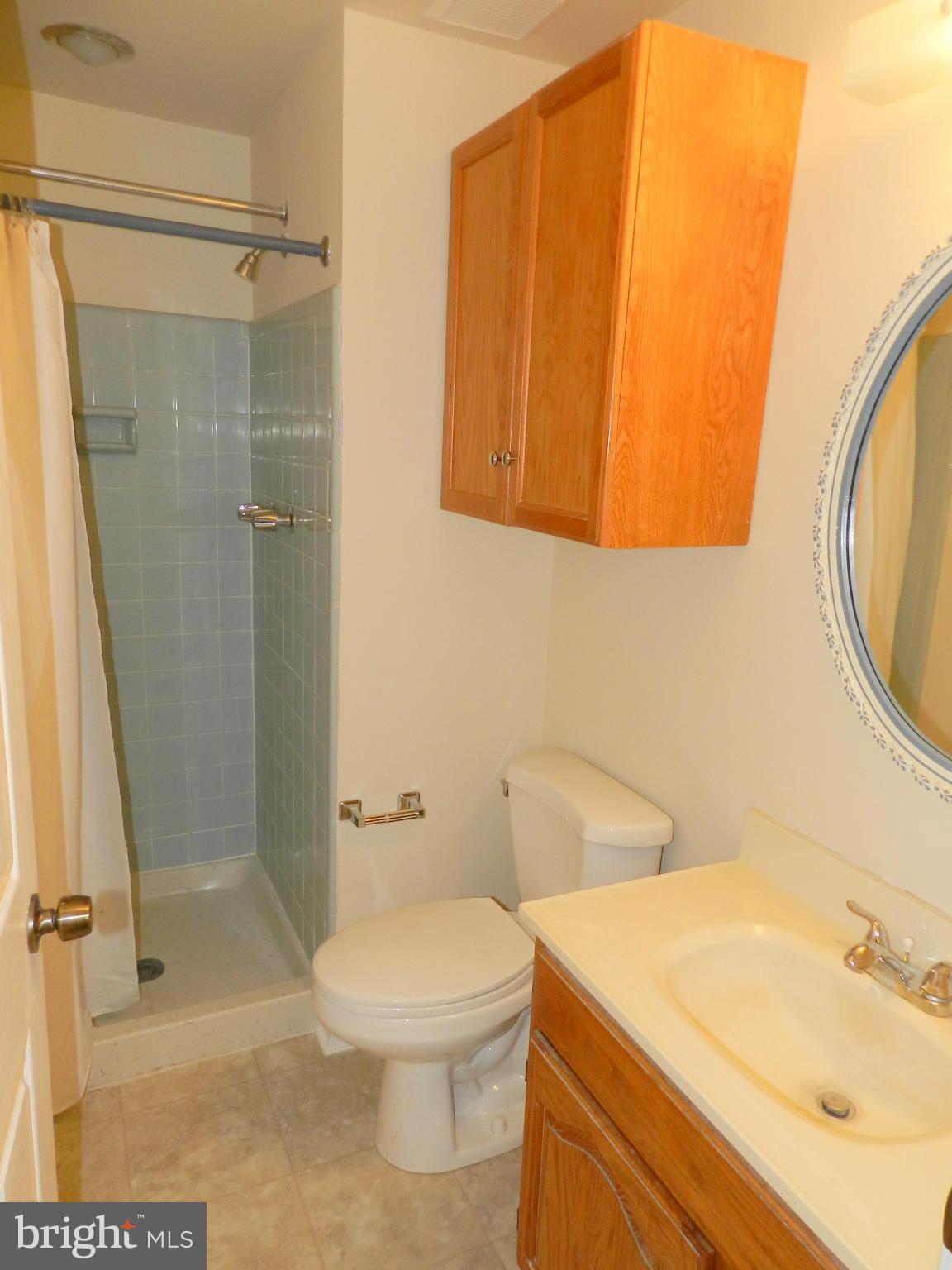 17567 Kohlhoss Road Poolesville, MD 20837 - Photo 17 of 25 a bathroom with a sink a toilet and shower