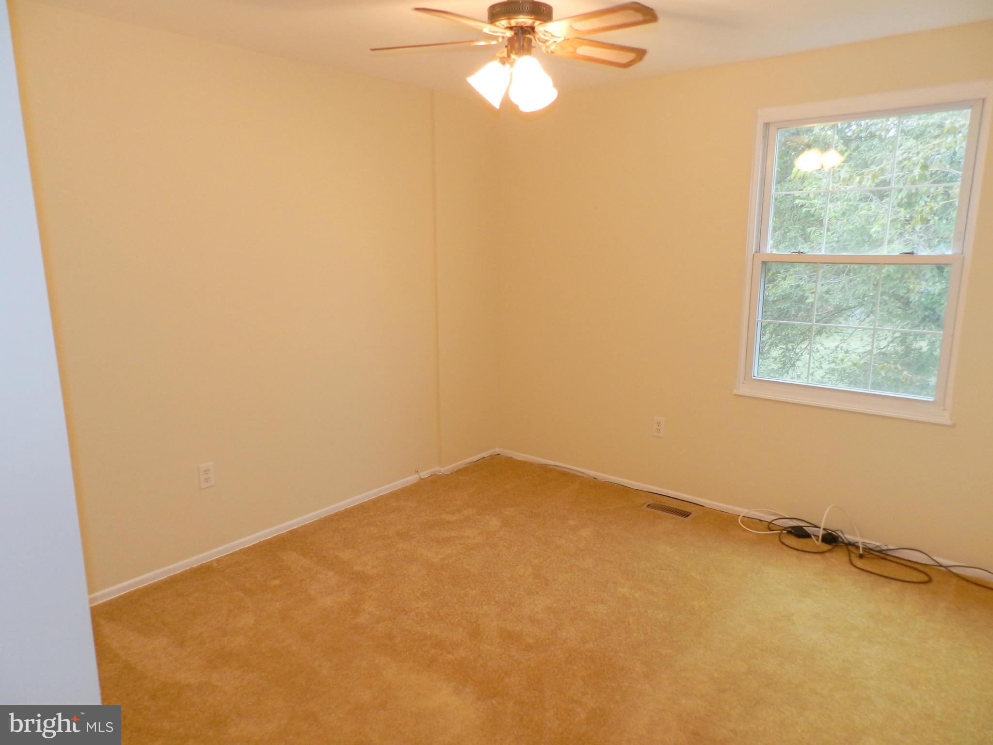 17567 Kohlhoss Road Poolesville, MD 20837 - Photo 20 of 25 an empty room with a window and a fan