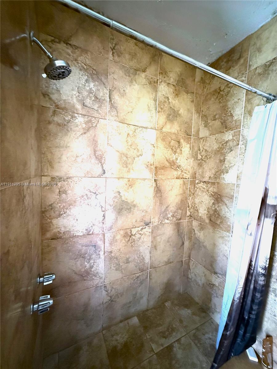 1041 Northwest 150th Street Miami, FL 33168 - Photo 12 of 27 a bathroom with a shower