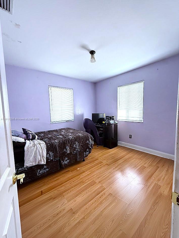 1041 Northwest 150th Street Miami, FL 33168 - Photo 13 of 27 a bedroom with a bed and window