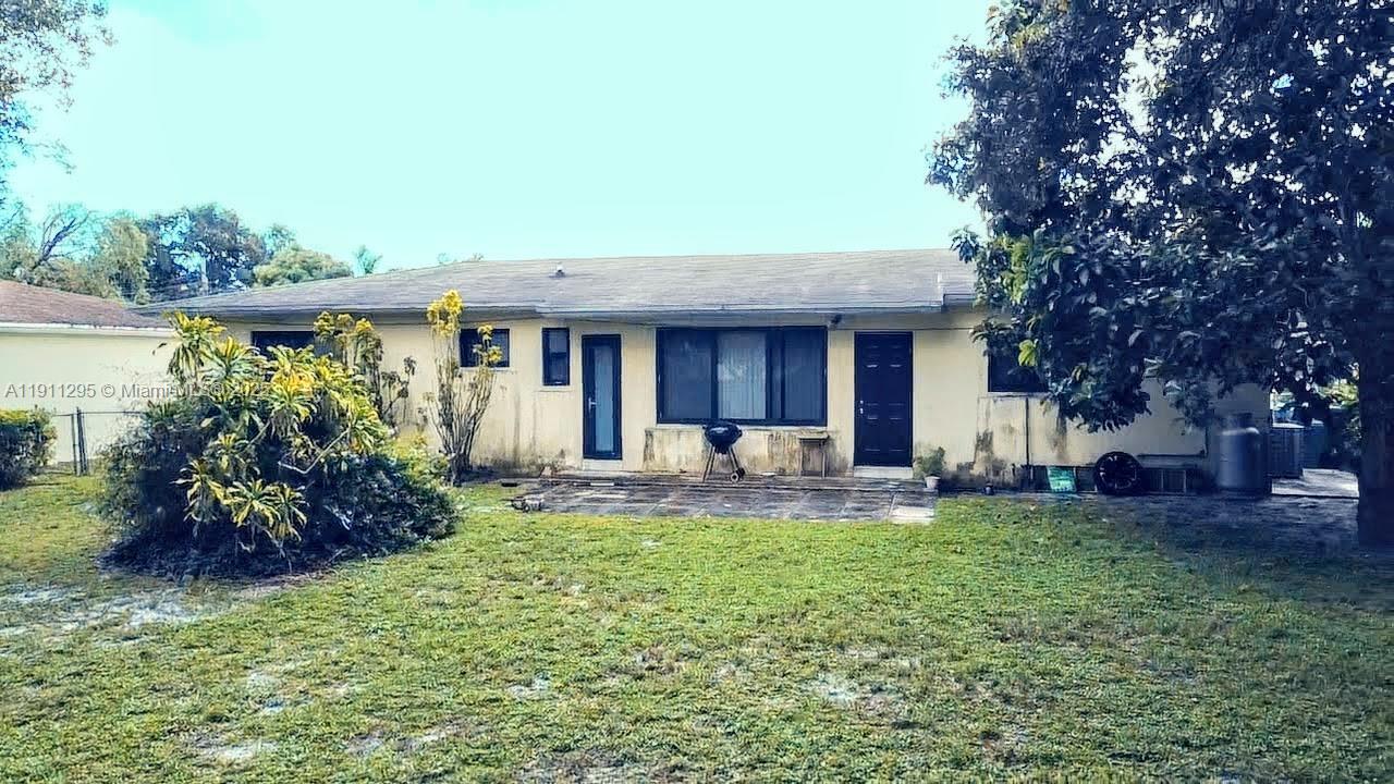 1041 Northwest 150th Street Miami, FL 33168 - Photo 17 of 27 a view of a house with a yard and sitting area