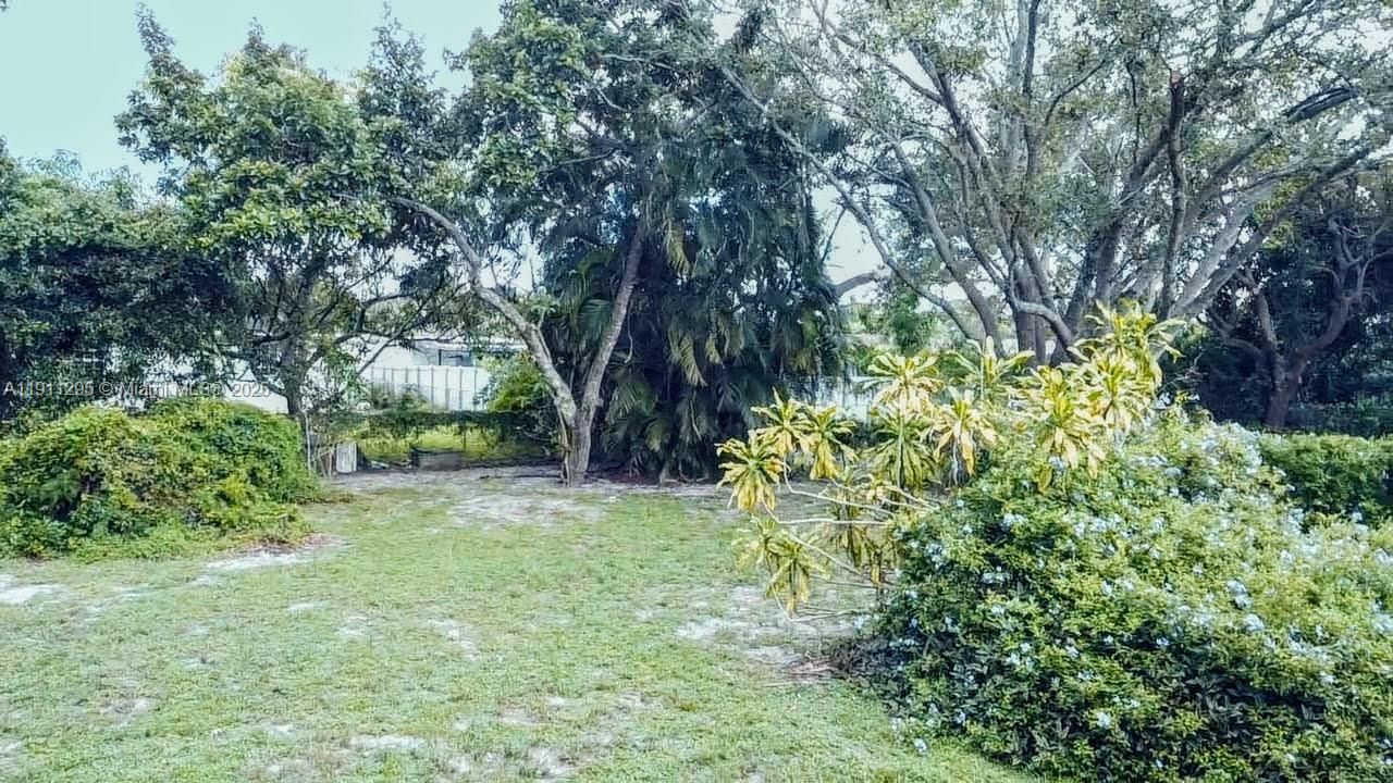 1041 Northwest 150th Street Miami, FL 33168 - Photo 24 of 27 a backyard of a house with lots of green space and garden view