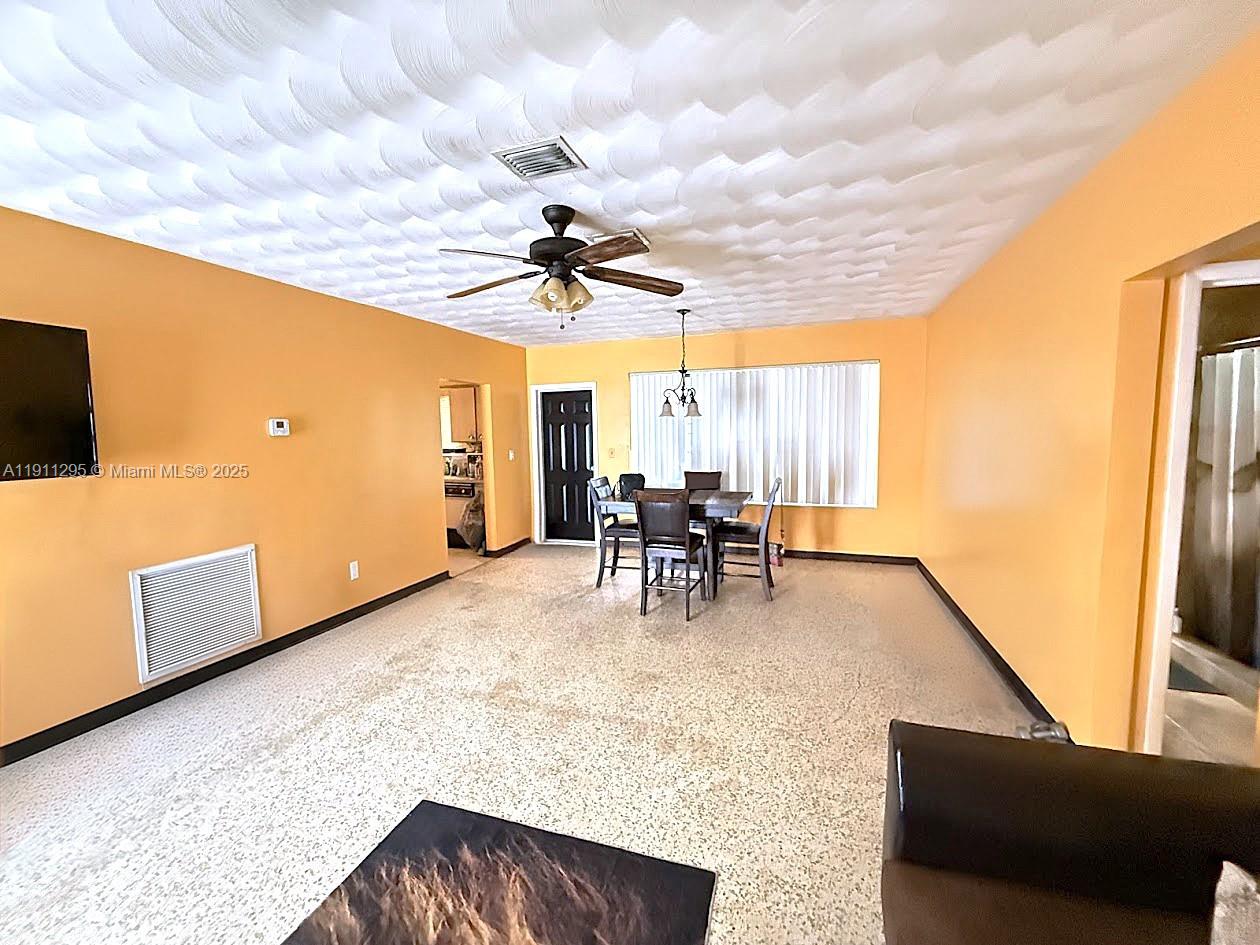 1041 Northwest 150th Street Miami, FL 33168 - Photo 5 of 27 a view of a livingroom with furniture and workspace