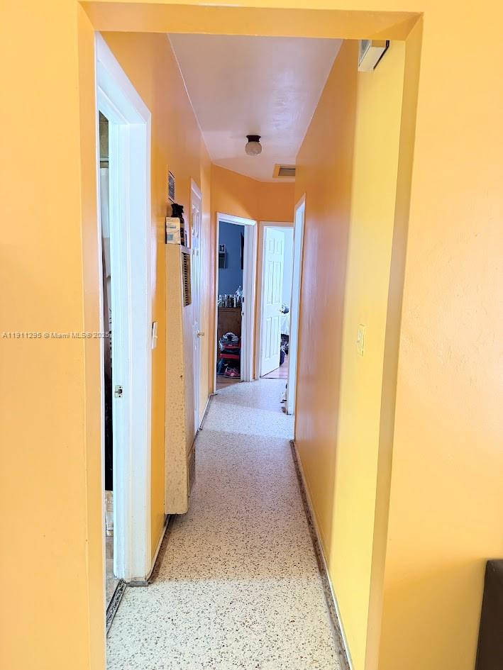 1041 Northwest 150th Street Miami, FL 33168 - Photo 8 of 27 a view of a hallway with wooden floor