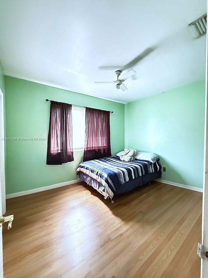 1041 Northwest 150th Street Miami, FL 33168 - Photo 9 of 27 a bedroom with a bed and window