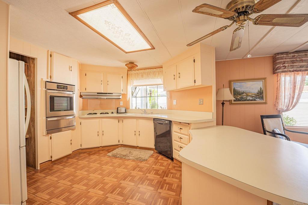 4650 Dulin Road, Unit 120 Fallbrook, CA 92003 - Photo 19 of 34 a kitchen with a refrigerator sink and cabinets