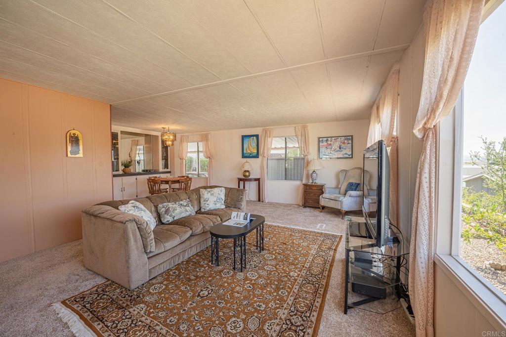4650 Dulin Road, Unit 120 Fallbrook, CA 92003 - Photo 21 of 34 a living room with furniture and a large window