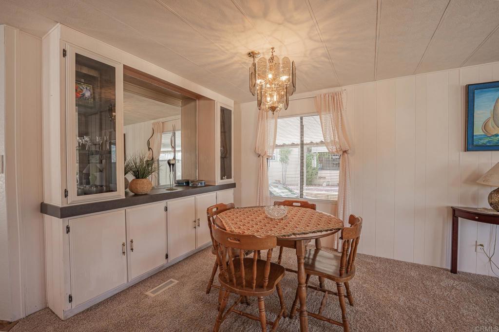 4650 Dulin Road, Unit 120 Fallbrook, CA 92003 - Photo 23 of 34 a view of a dining room with furniture and chandelier