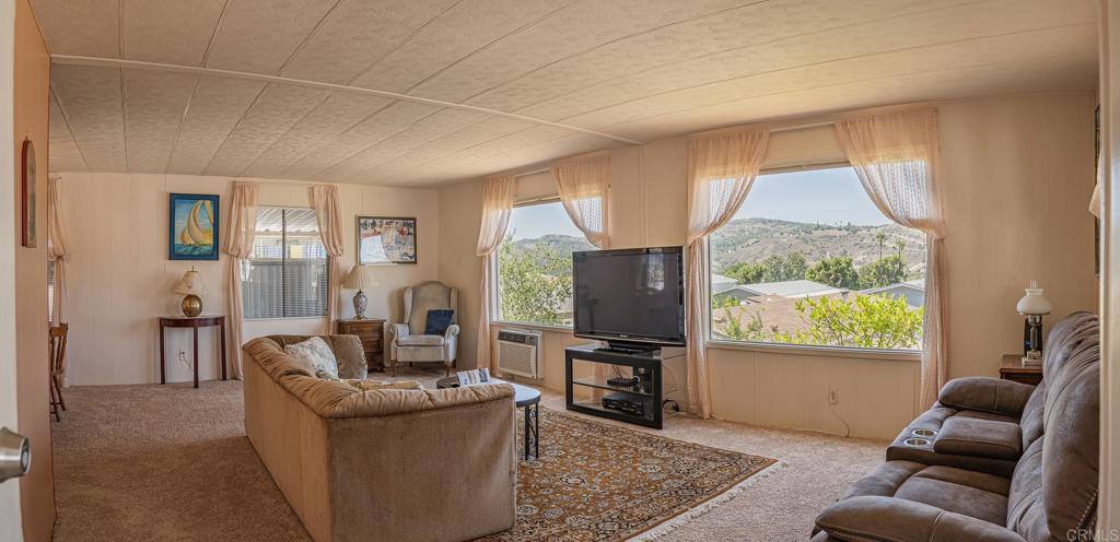 4650 Dulin Road, Unit 120 Fallbrook, CA 92003 - Photo 24 of 34 a living room with furniture and a flat screen tv