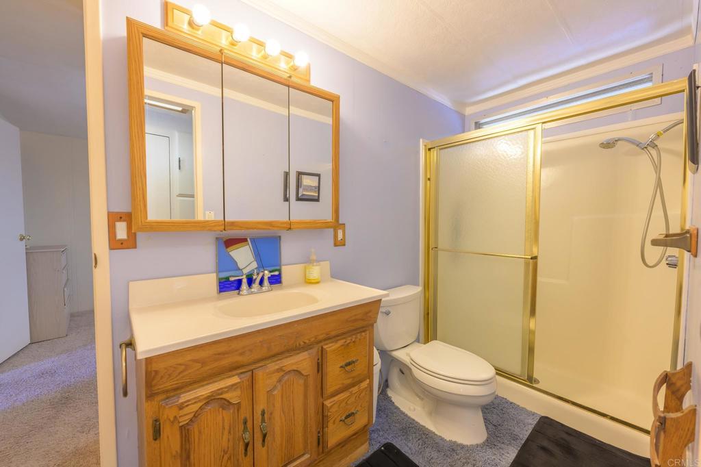 4650 Dulin Road, Unit 120 Fallbrook, CA 92003 - Photo 8 of 34 a bathroom with a sink toilet vanity and shower