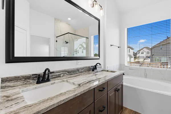 a bathroom with a sink double vanity and a mirror