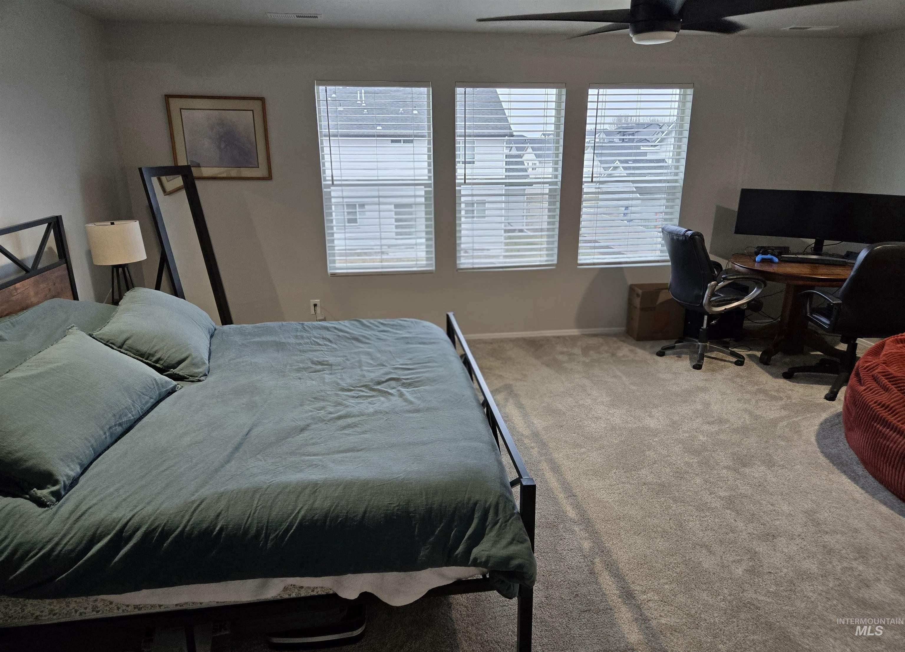 4098 East Mets Street Nampa, ID 83686 - Photo 19 of 34 Carpeted bedroom featuring multiple windows, ceiling fan, and a desk