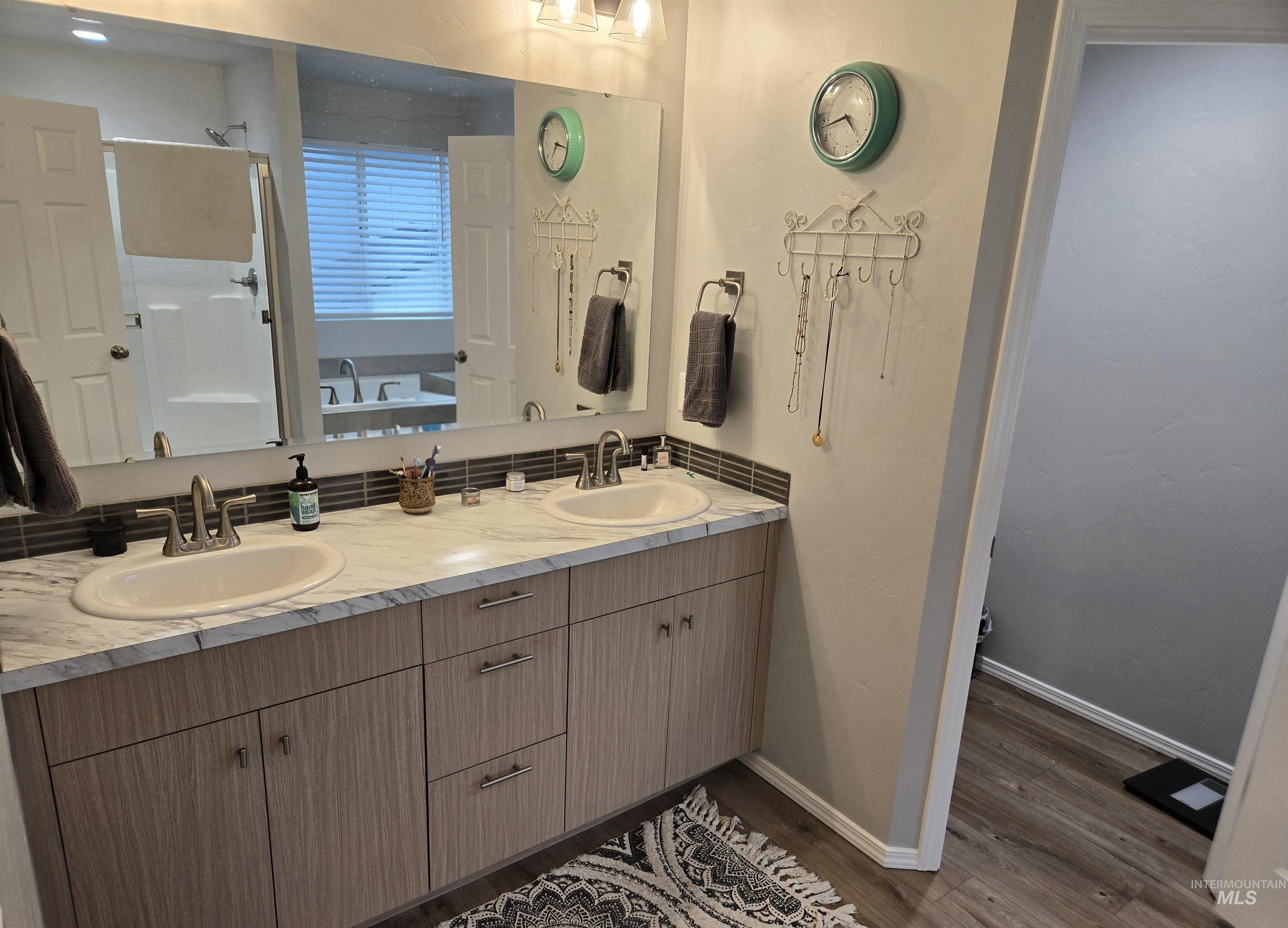 4098 East Mets Street Nampa, ID 83686 - Photo 21 of 34 Full bath featuring double vanity, dark wood-type flooring, a stall shower, and a bath
