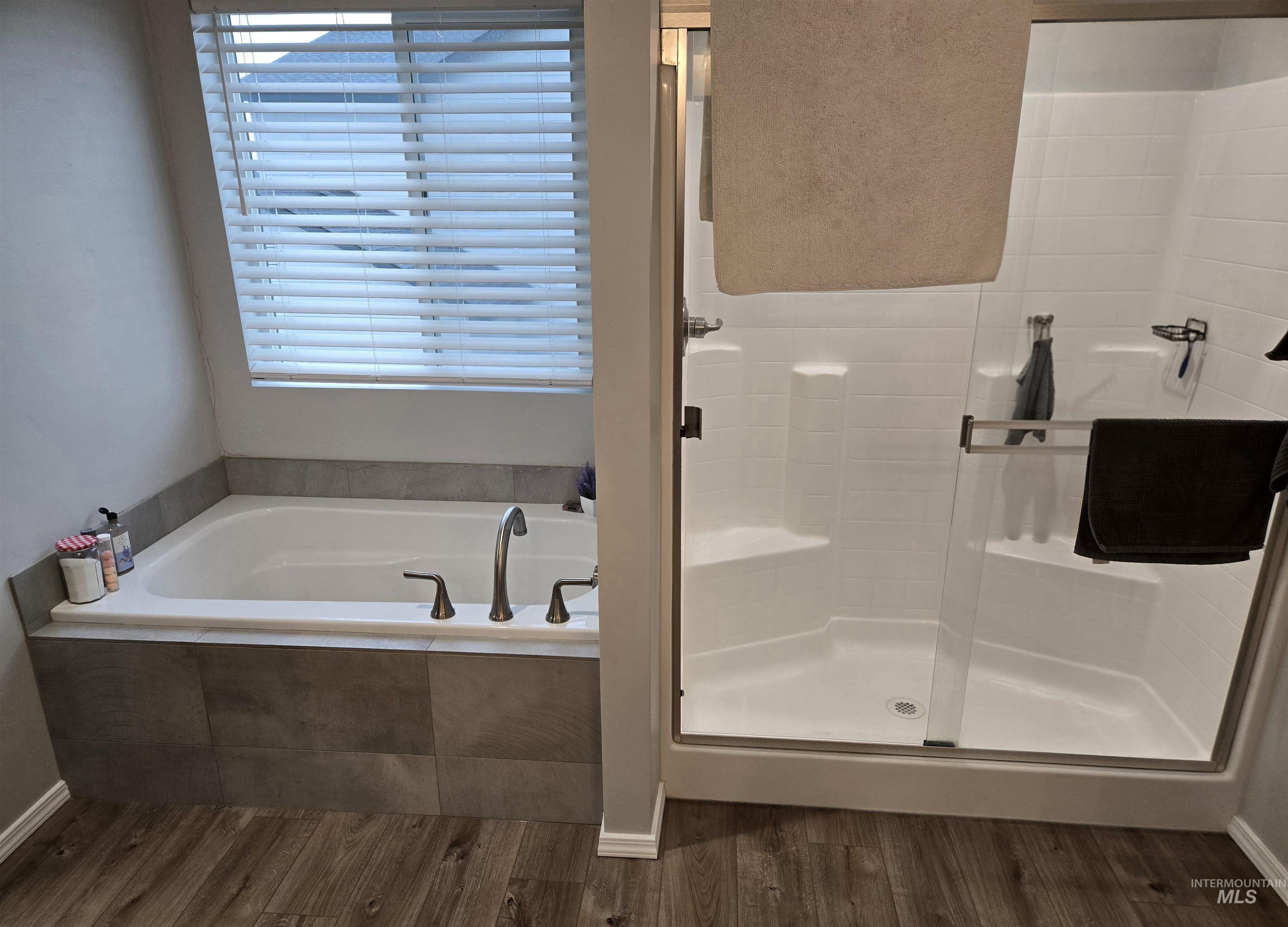4098 East Mets Street Nampa, ID 83686 - Photo 22 of 34 Full bathroom featuring a garden tub, a shower stall, and dark wood-type flooring