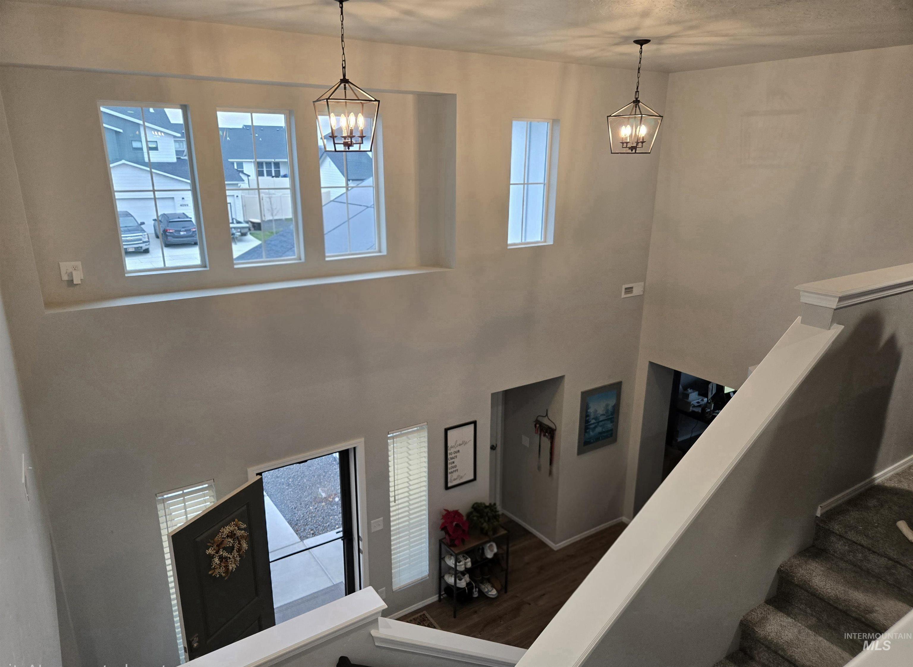 4098 East Mets Street Nampa, ID 83686 - Photo 4 of 34 Stairs featuring wood finished floors, healthy amount of natural light, and a towering ceiling