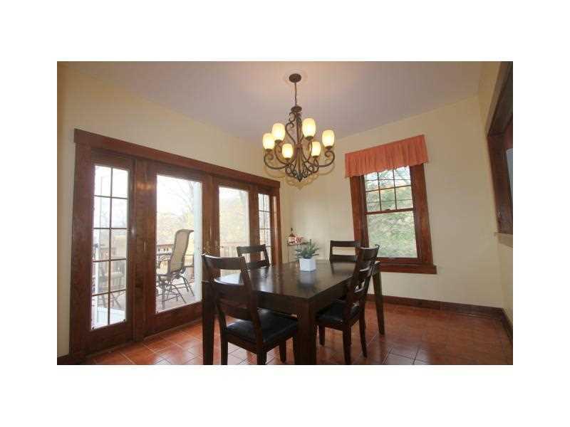 443 Walnut Road Pittsburgh, PA 15202 - Photo 11 of 25 Dining Room. Another view of the Dining Room shows beautiful views of the natural landscape through glass doors on the left and a window on the far wall.