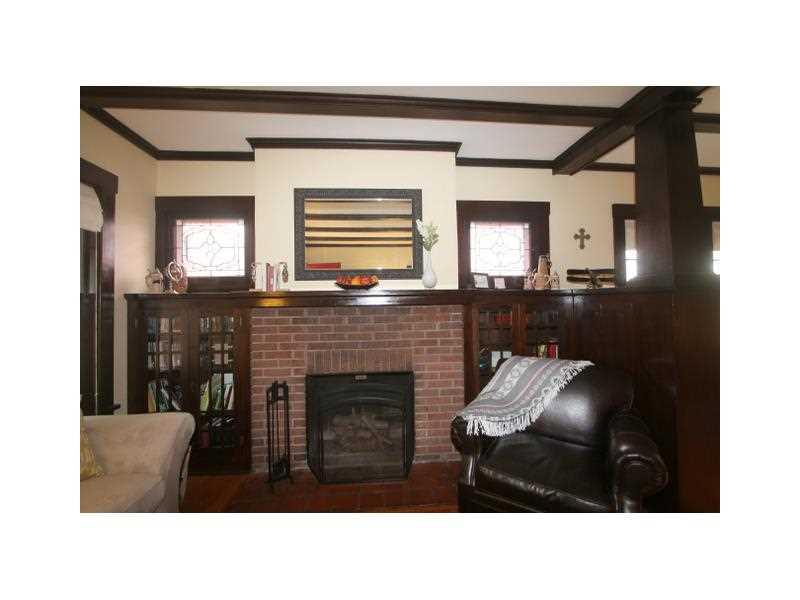 443 Walnut Road Pittsburgh, PA 15202 - Photo 5 of 25 Family Room. A picture of casual elegance, this view of the Family Room highlights the brick fireplace with built-in cabinets on either side and two stained glass windows above the cabinets. A spacious yet cozy space to relax.