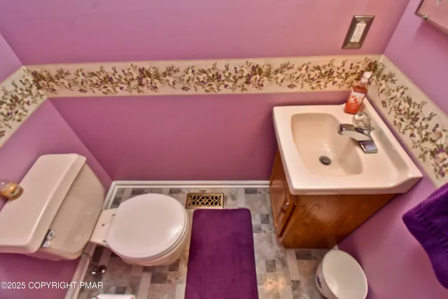 a bathroom with a toilet mirror and sink