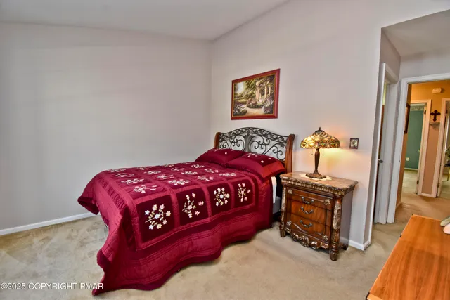 a bedroom with a bed and a painting on the wall