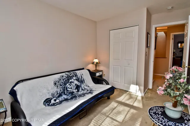 a bedroom with a bed and a potted plant