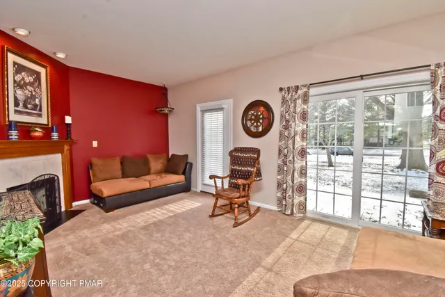 a living room with furniture a clock and a fireplace