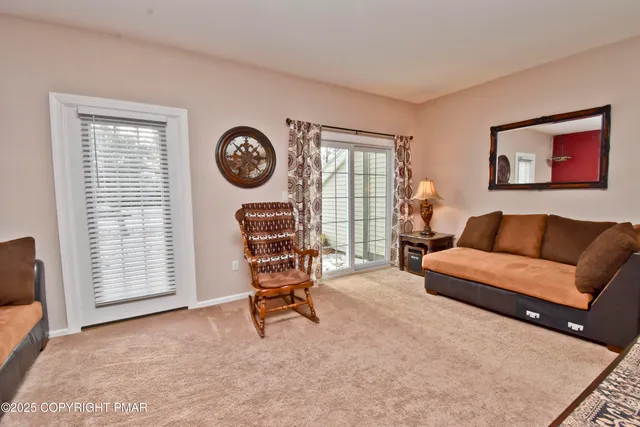 a living room with furniture a clock and a window