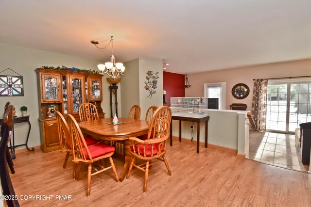 a view of a dining room with furniture and chandelier