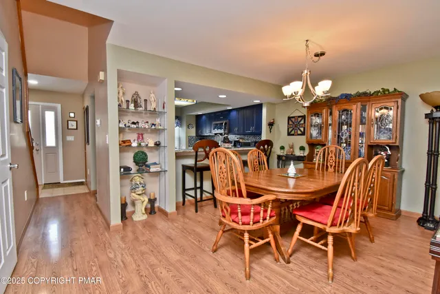 a dining room with furniture and wooden floor