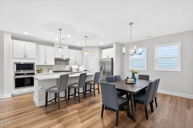 a large kitchen with a table and chairs