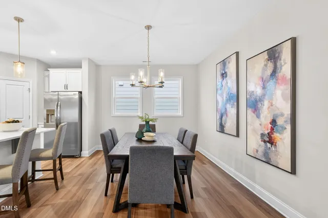 a view of a dining room with furniture wooden floor and chandelier
