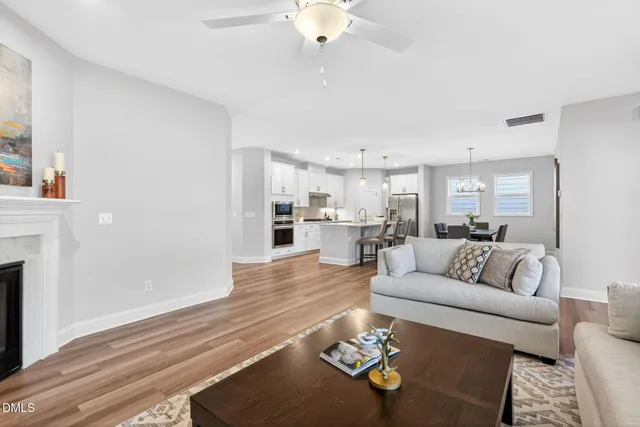 a living room with furniture kitchen view and a fireplace
