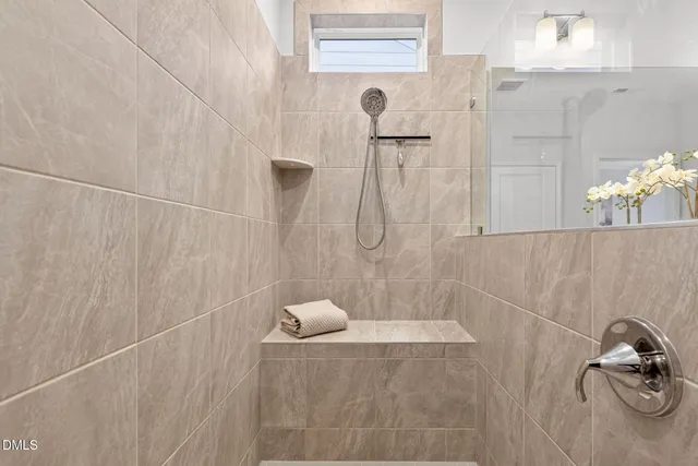 a bathroom with a double vanity sink mirror and shower