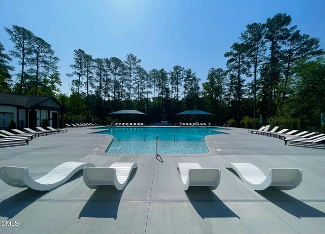 an aerial view of a house with a yard and lake view