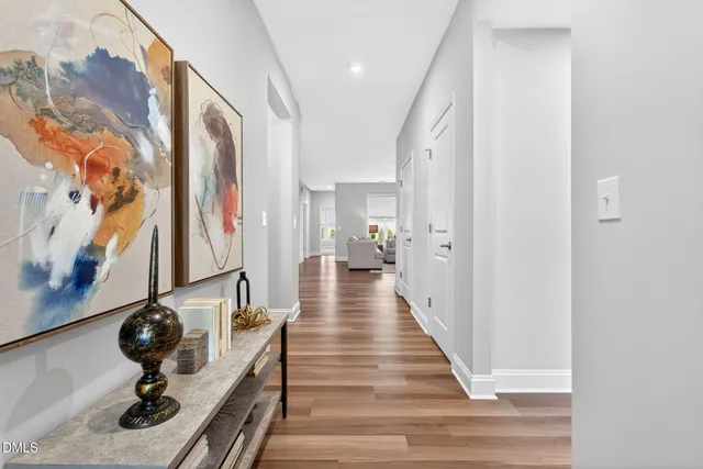 a view of a hallway with wooden floor and staircase