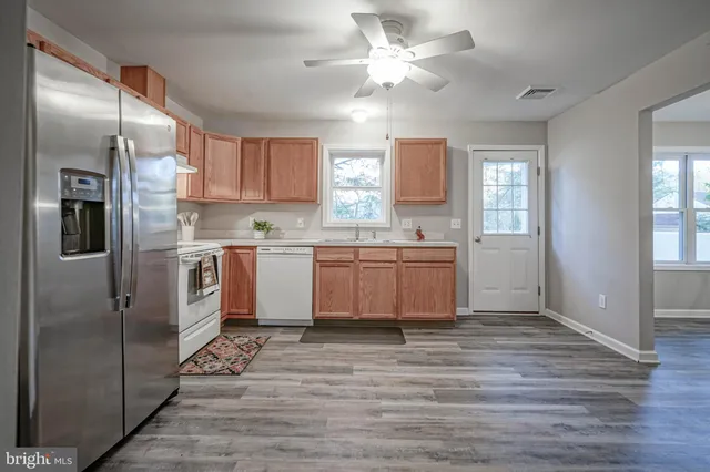a view of a kitchen with a sink and a window