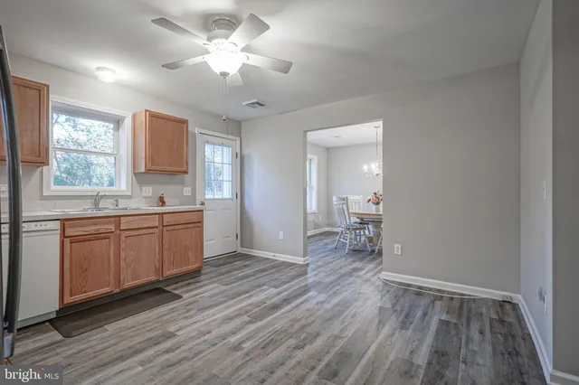 a bathroom with a toilet a sink a vanity and mirror